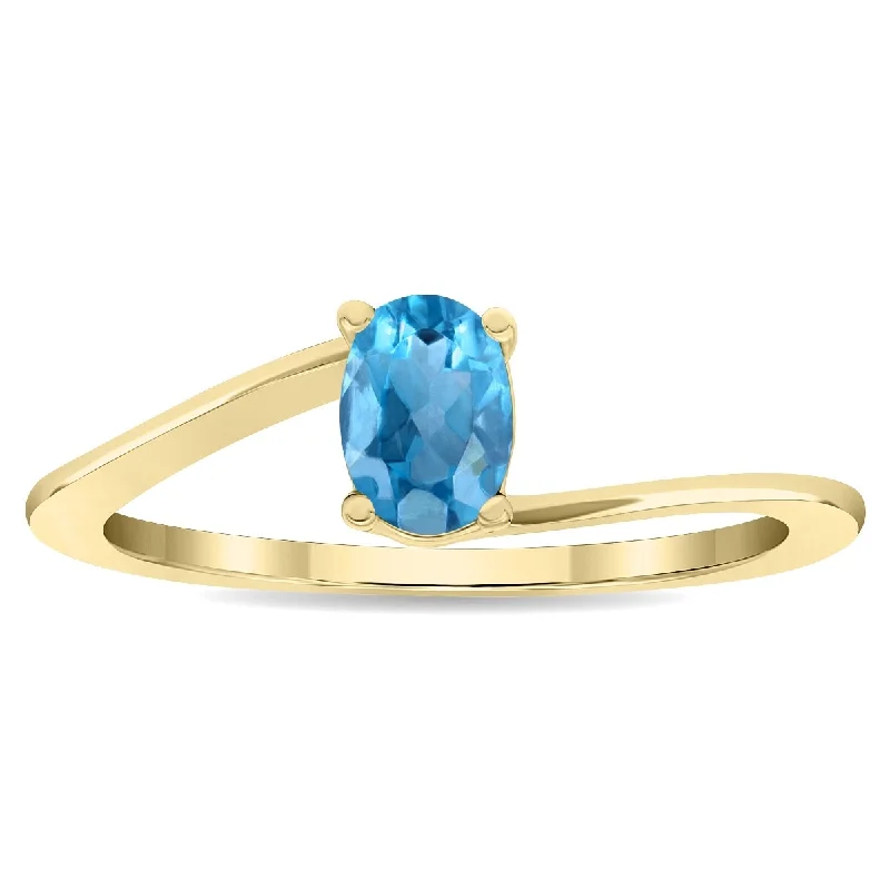 Women’s eco-friendly ring-Women's Solitaire Oval Shaped Blue Topaz Wave Ring in 10K Yellow Gold